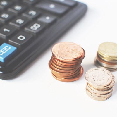 A generic image of coins and a calculator