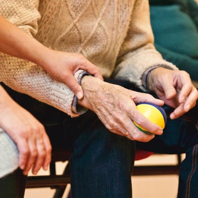 a generic image to represent caring, showing an older person with someone holding their arm