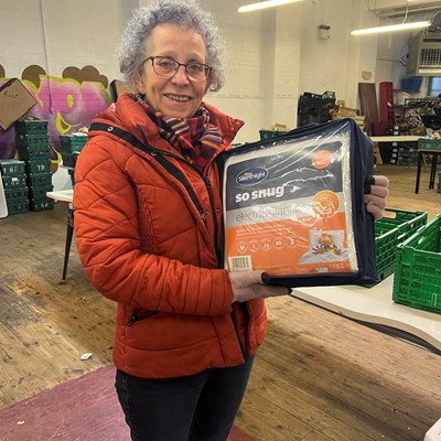 Chair of Woodgate Community Food, Eve Hill, with one of the blankets