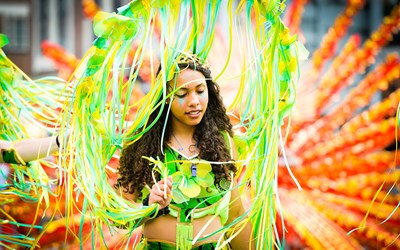 colourful image of lady from Leicester's Caribbean Carnival