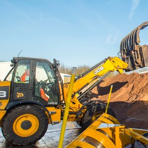 Digger filling a gritting lorry