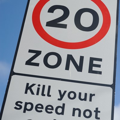 20moh zone sign on a city street