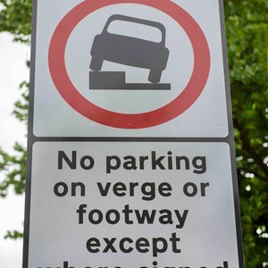 Road sign showing controlled pavement parking