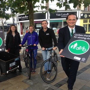 Image: Staff from Sustrans and Leicester City Council with the new 'considerate cyclists welcome' signs and deputy city mayor Cllr Adam Clarke (far right)