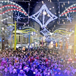 Crowds under the Christmas lights on Humberstone Gate