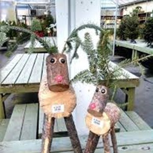 Image: A picture of two reindeer ornaments made from recycled logs