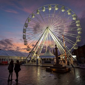 Wheel of Light and ice rink at sunset in Jubilee Square