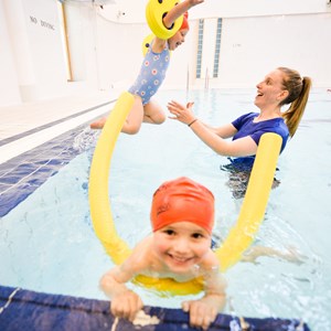 Two children having swimming lessons in a pool