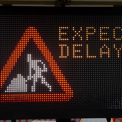 Road work sign warning of expected delays