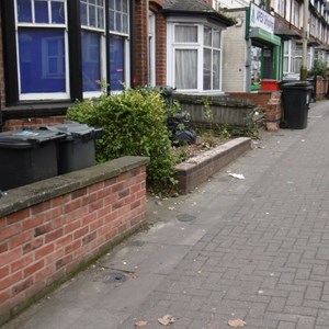 Damaged and broken garden walls on Evington Road