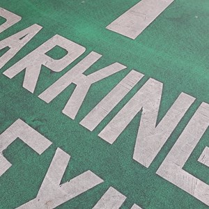 Sign for car park written on the road
