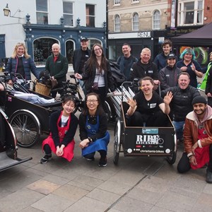 Image shows last month's Open Streets event, with people in rickshaws and enjoying the street scene