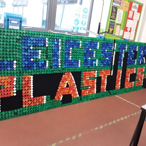 Image: A scoreboard saying 'Leicester 1 Plastics 0' made out of plastic bottle tops by Ellesmere College students