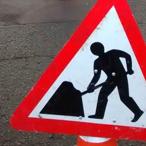 Men at work road sign