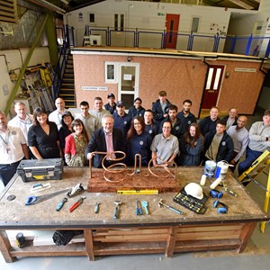 Image shows staff, apprentices, city mayor Peter Soulsby and Cllr Elly Cutkelvin at the city council's construction training centre