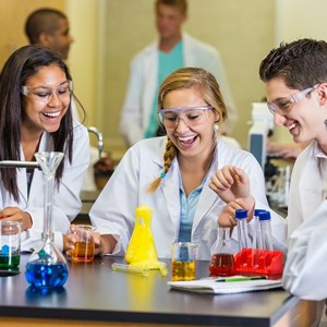 Image: A stock photograph of secondary school students in a science lesson