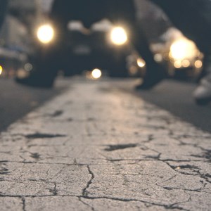 Feet crossing a road