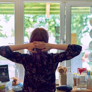 Image: An illustration of a woman inside looking out of a win