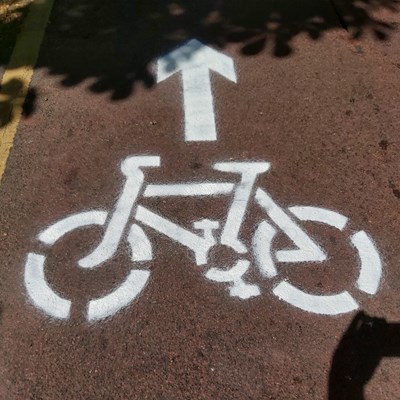 An image of a bike and arrow stencilled onto Road in Leicester to signify a temporary bike lane