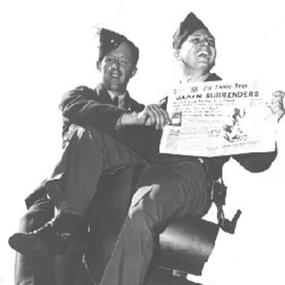 Two soldiers with newspaper headline announcing Japan's surrender