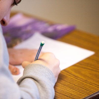 Close up of a pupil writing in class
