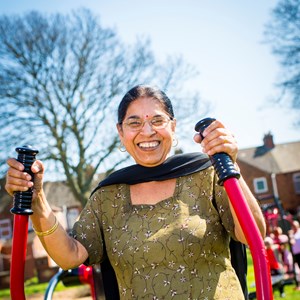 A woman using outdoor gym equipment in Leicester