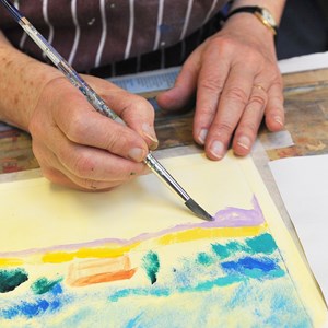 Close-up of hands painting a picture