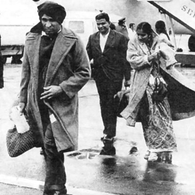 Ugandan Asians arriving in the rain at Stansted Airport in 1972