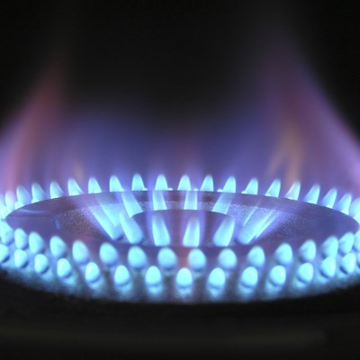 a gas ring burning bright with blue flames