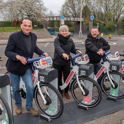 PIcture shows Cllr Adam Clarke, Janet Hudson from Leicester City Council and Tim Hudson from Ride On at the new ebike docking station on Stephenson Drive