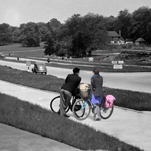 CAPTION: This composite pic of Mickleham bypass in Surrey shows similar period cycle tracks to those being restored in Leicester. It includes modern cyclists, in colour, to demonstrate how the tracks can be restored and reused. CREDIT: Carlton Reid