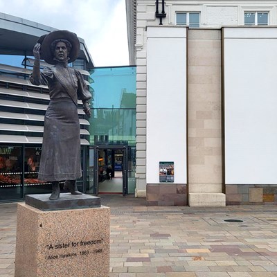Alice Hawkins statue with Picturing the Past panel in background