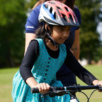 A young girl riding a bike