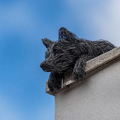 The fox sculpture on the top of the Corn Exchange wall