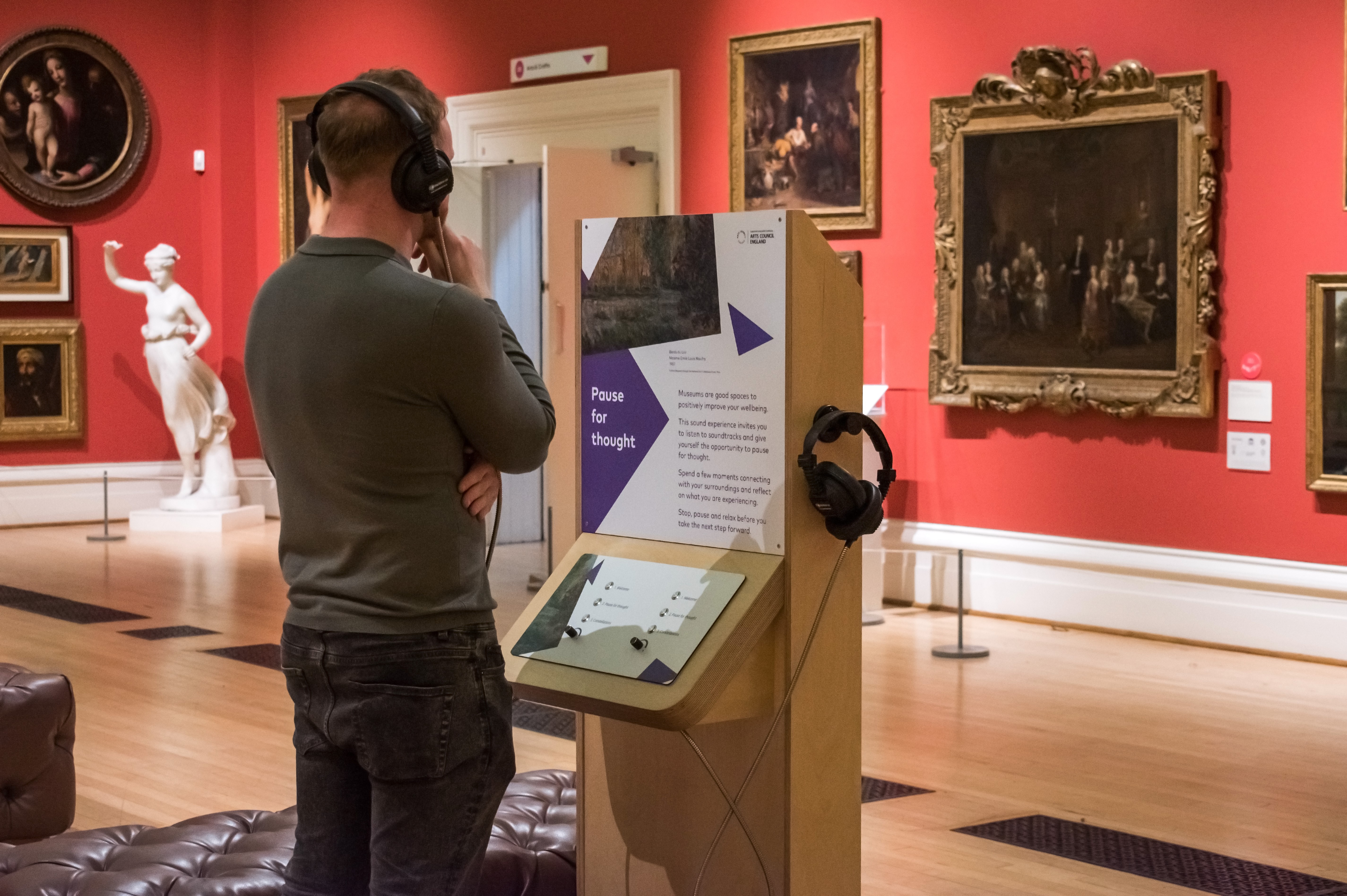 Visitor using the sound unit at Leicester Museum and Art Gallery