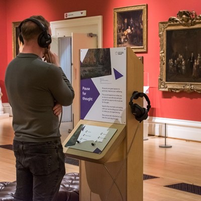Visitor using the sound unit at Leicester Museum and Art Gallery