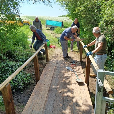 Local volunteers working on a footbridge