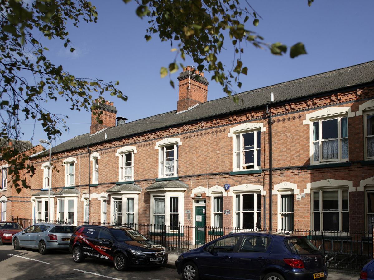 A row of terraced houses with a blue sky background.