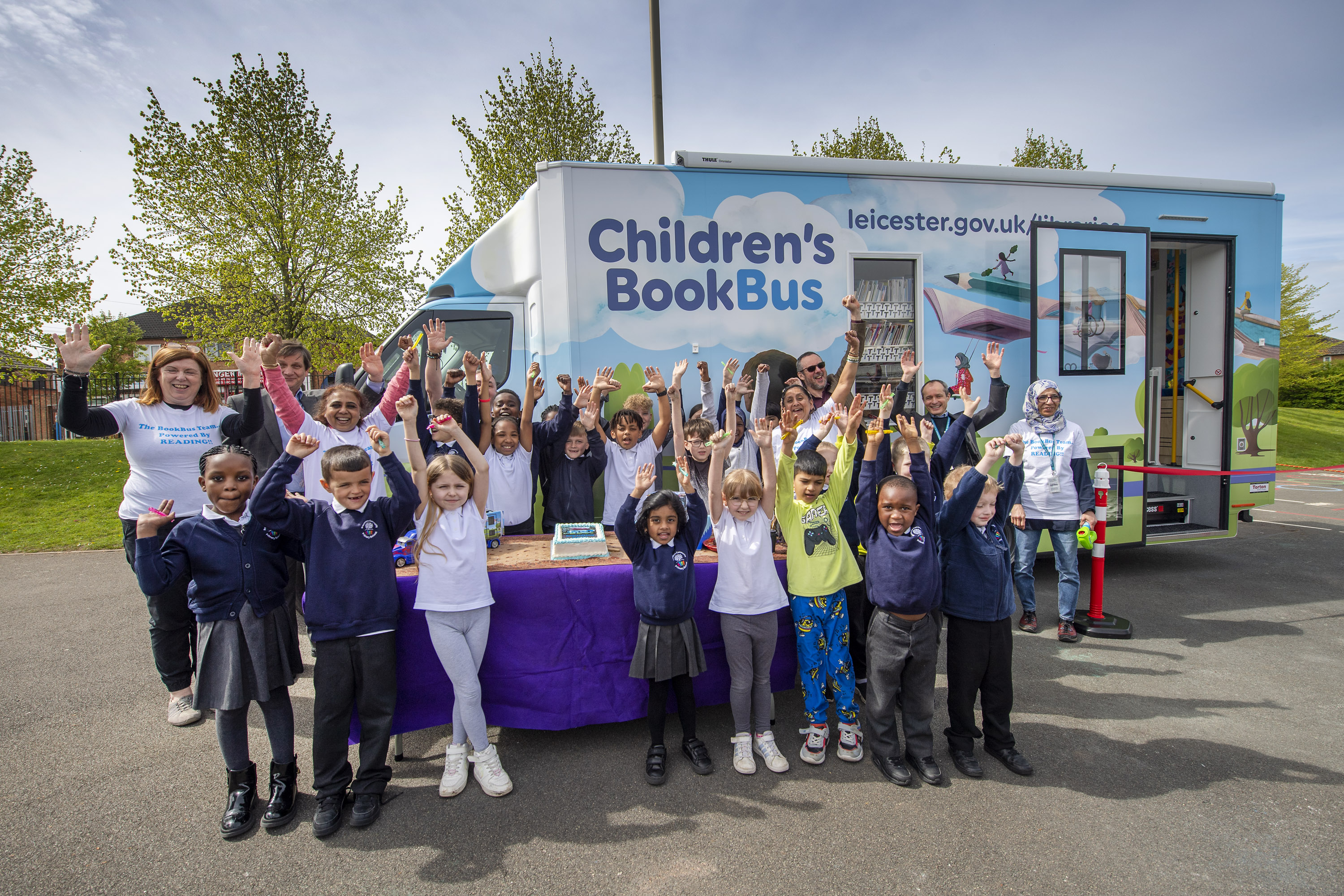 Children at Braunstone Community Primary celebrate the arrival of the new BookBus