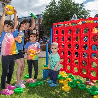 Children playing giant games at a playday in Leicester