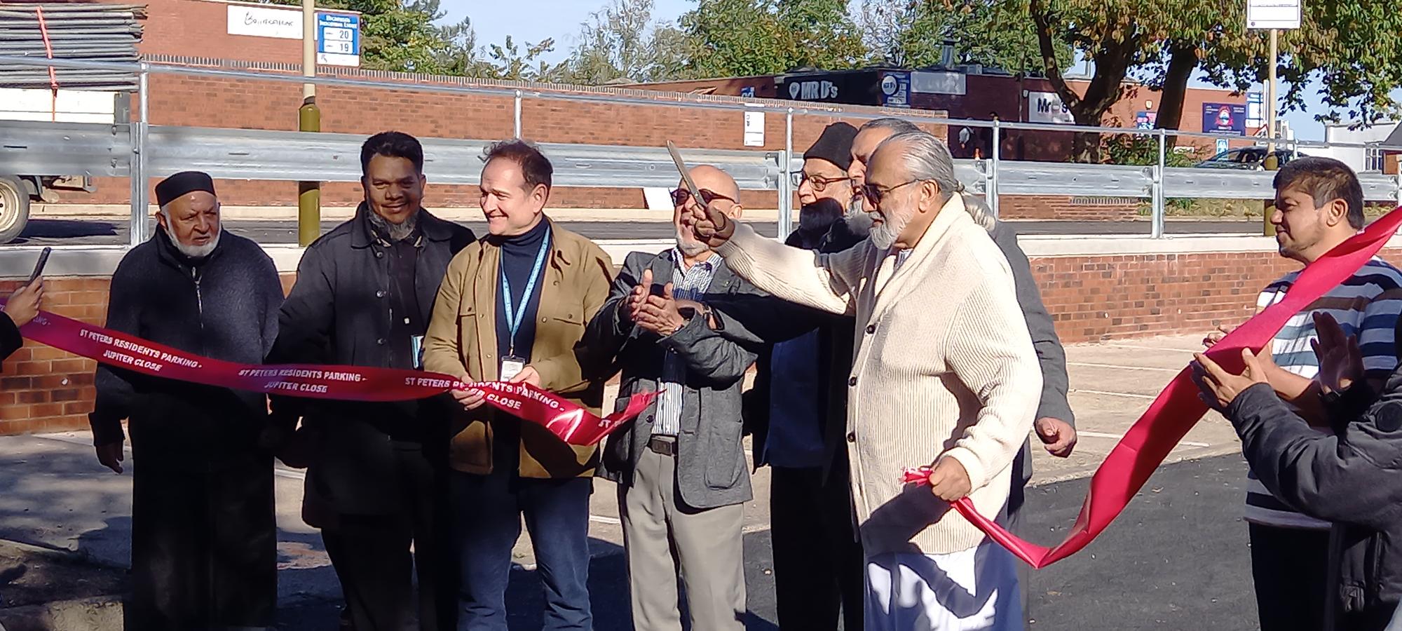 Ward councillors, housing staff and local people cut a ribbon at the new Jupiter Close parking spaces site