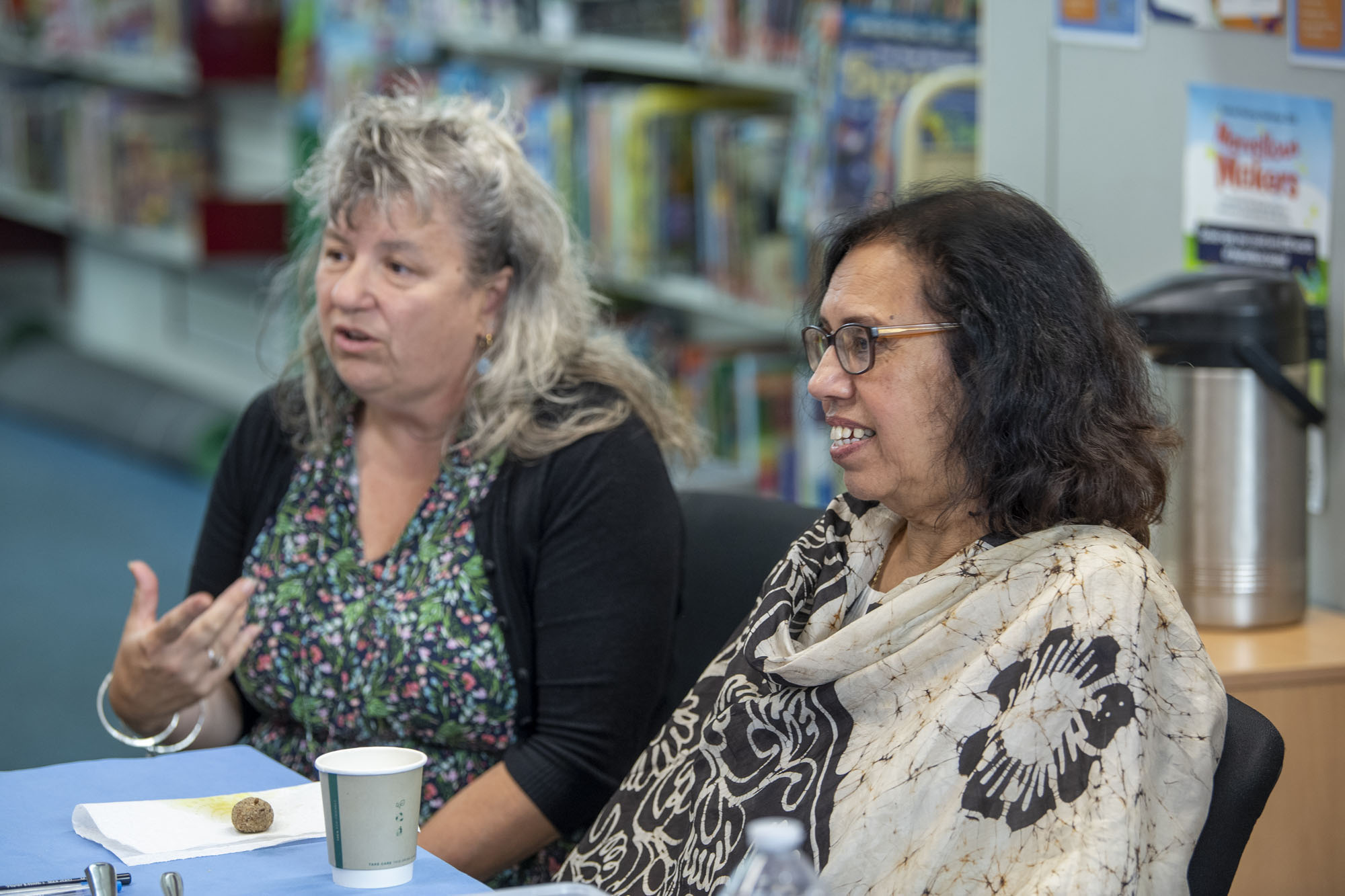People sitting talking in a library