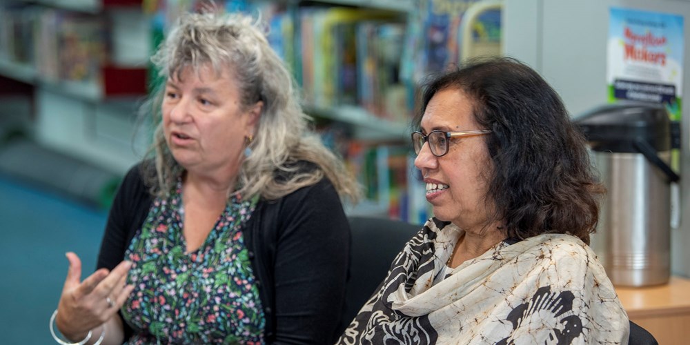 People sitting talking in a library