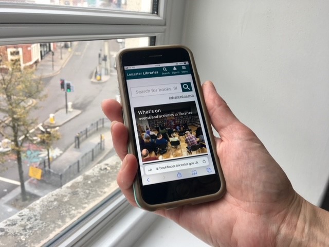 A picture of the new libraries website on a mobile phone