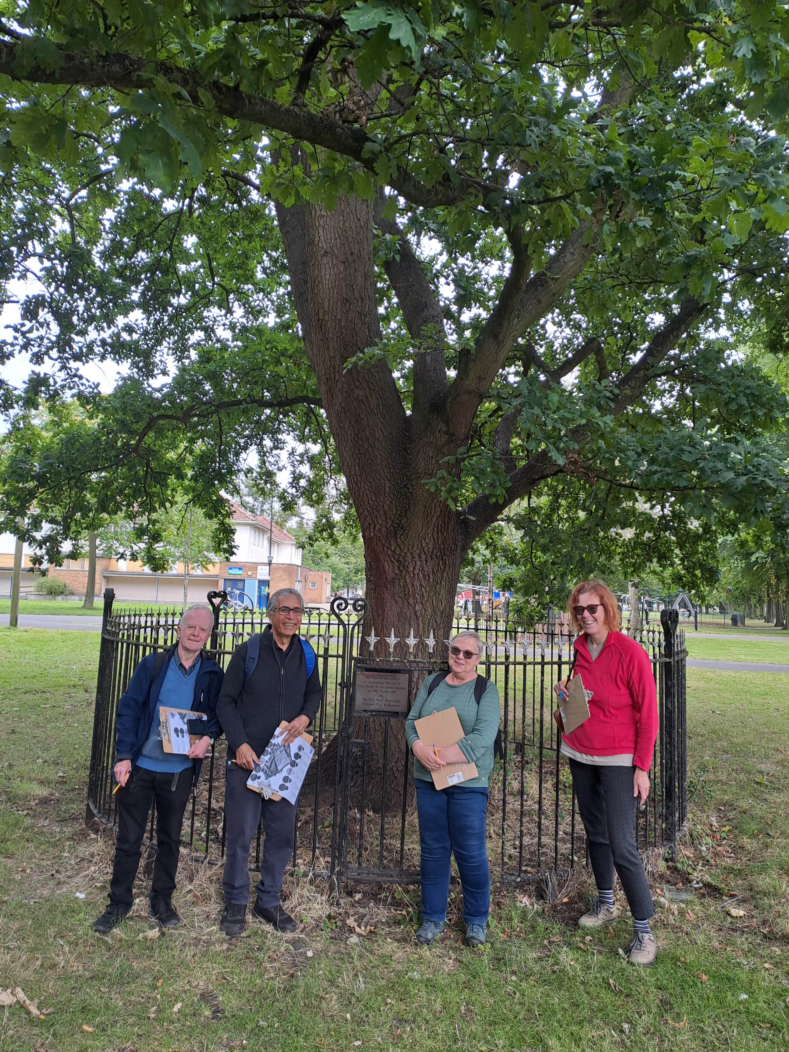Leicester's tree wardens with the oak tree that was planted in 1946 to mark the visit of the King and Queen.