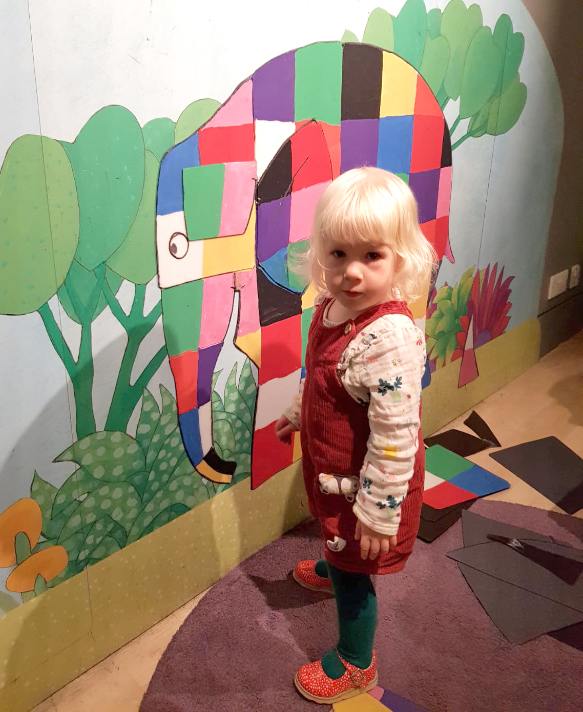 A young fan gets close to Elmer the Patchwork Elephant