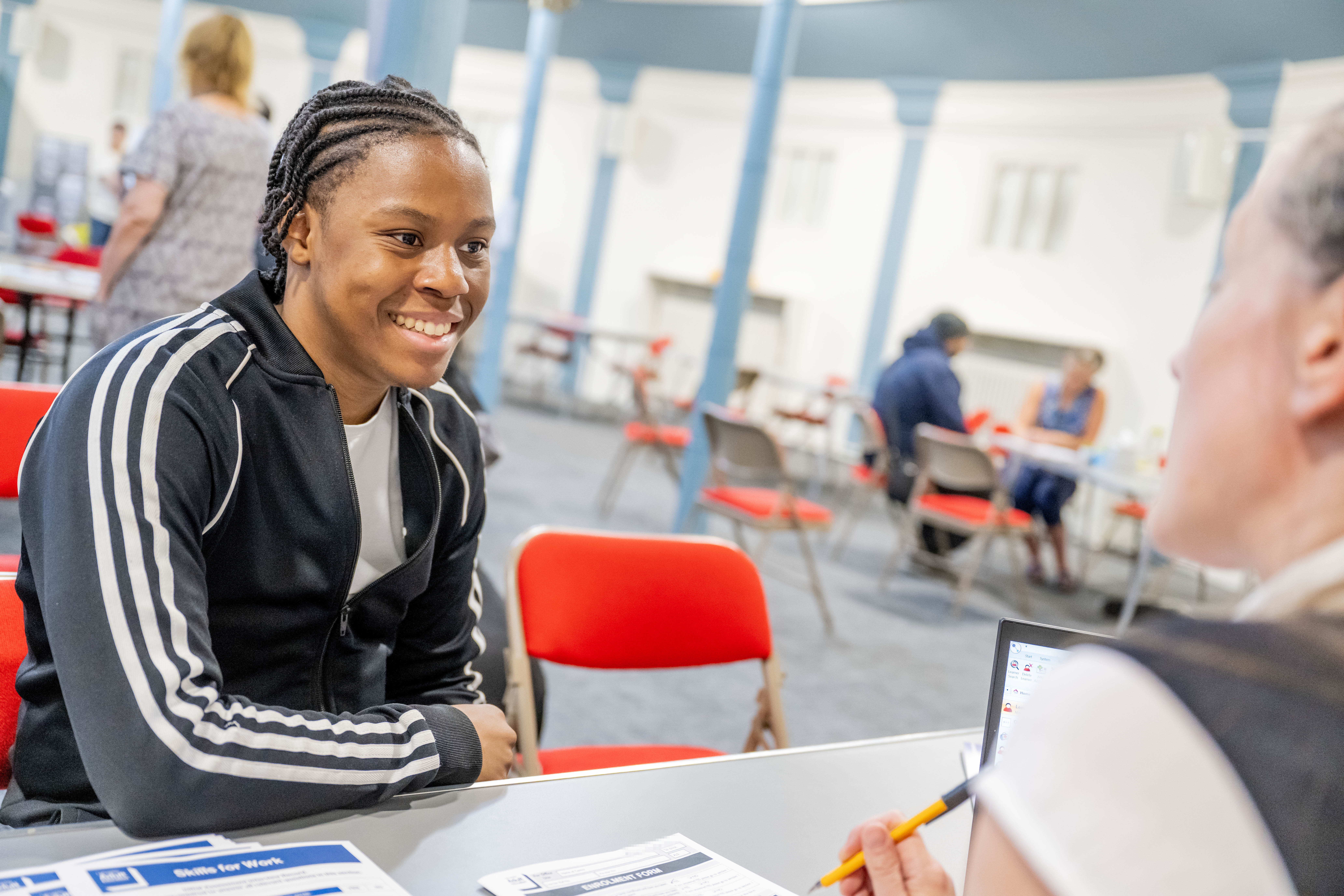 a picture of someone talking to an adult learning tutor