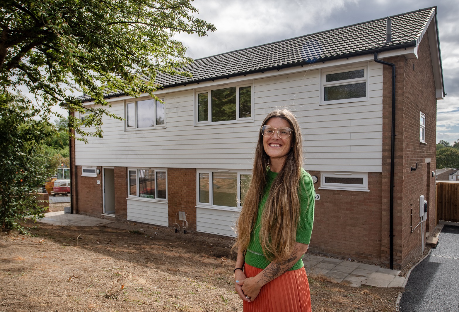 Cllr Cutkelvin outside a newly refurbished home at Hospital Close