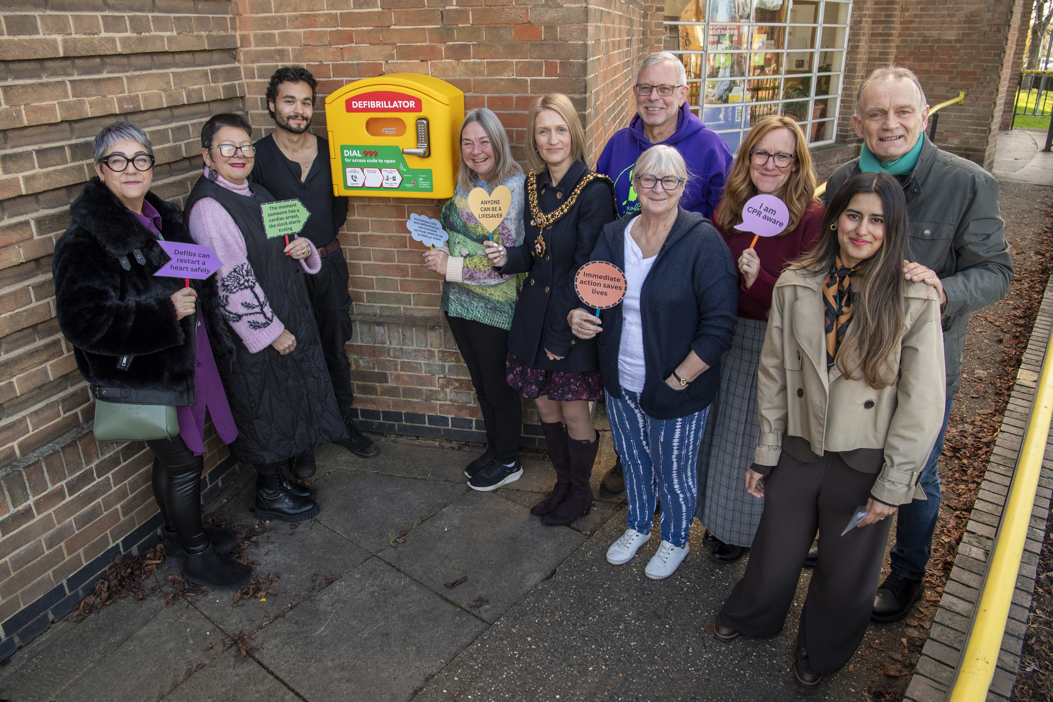 Members of the community and councillors with the new defib at Pork Pie Library