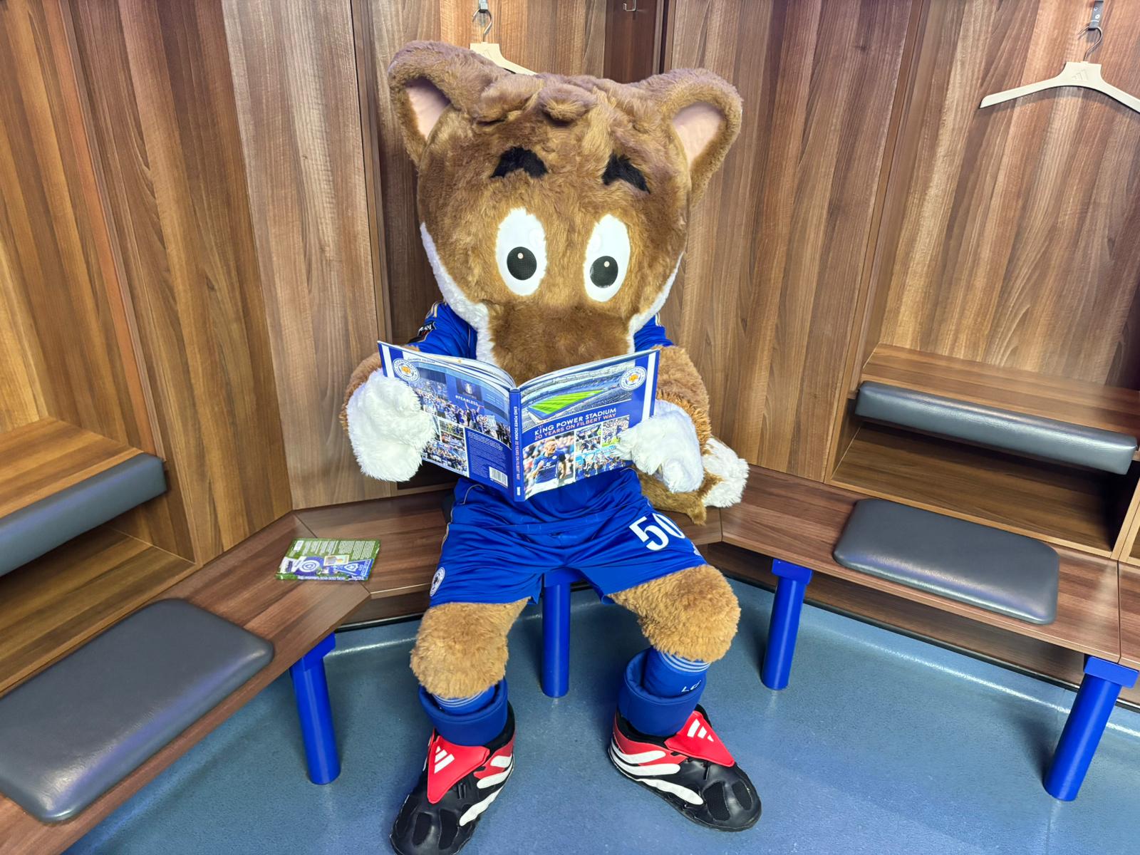 Leicester City Football Club mascot Filbert Fox reading a book